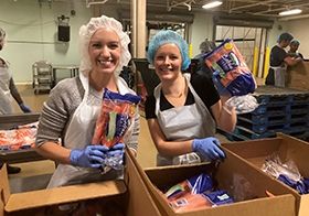 Rachel Walz and Claire McCann volunteer at SJC's annual day of service. 