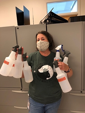 Safety first! Cindy Carter, OMRF Laboratory Manger, distributes bottles of disinfectant around the organization.