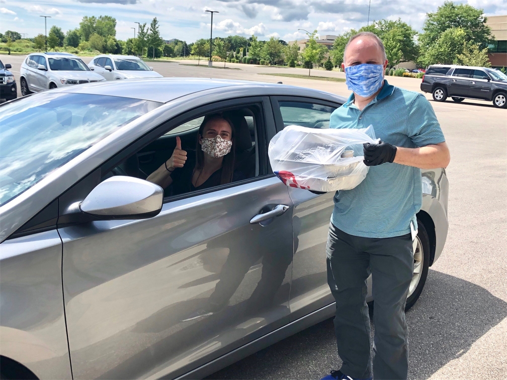 Associates attend drive thru event to pick up meals to support local restaurants in response to COVID-19