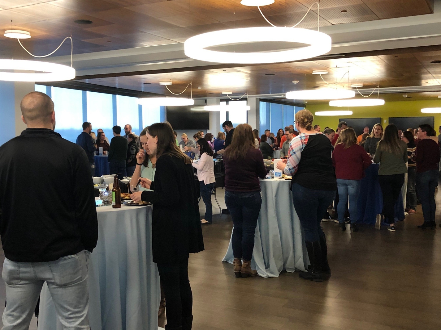 Associates gather to celebrate the holiday season in their brand new cafeteria that can be used as meeting space as well as for larger company sponsored events.