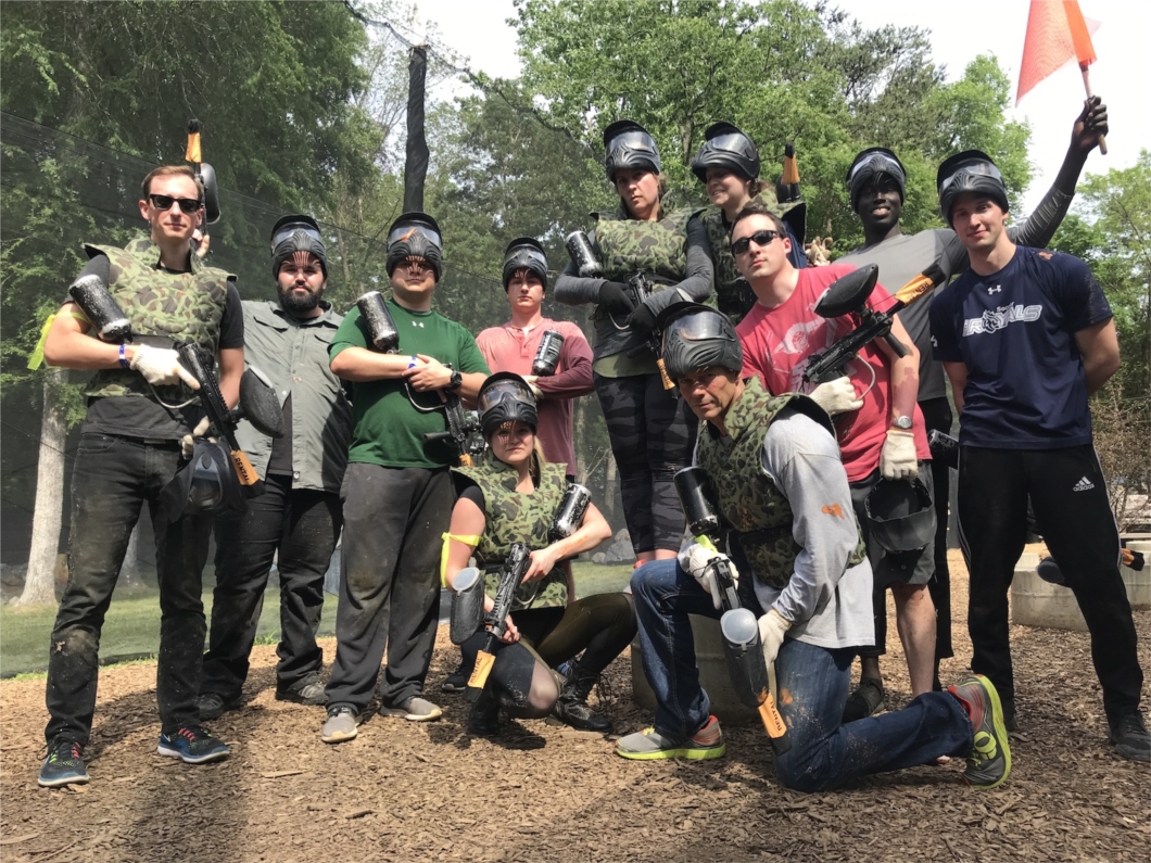 Adaptive Health employees playing paintball at a team-building event.