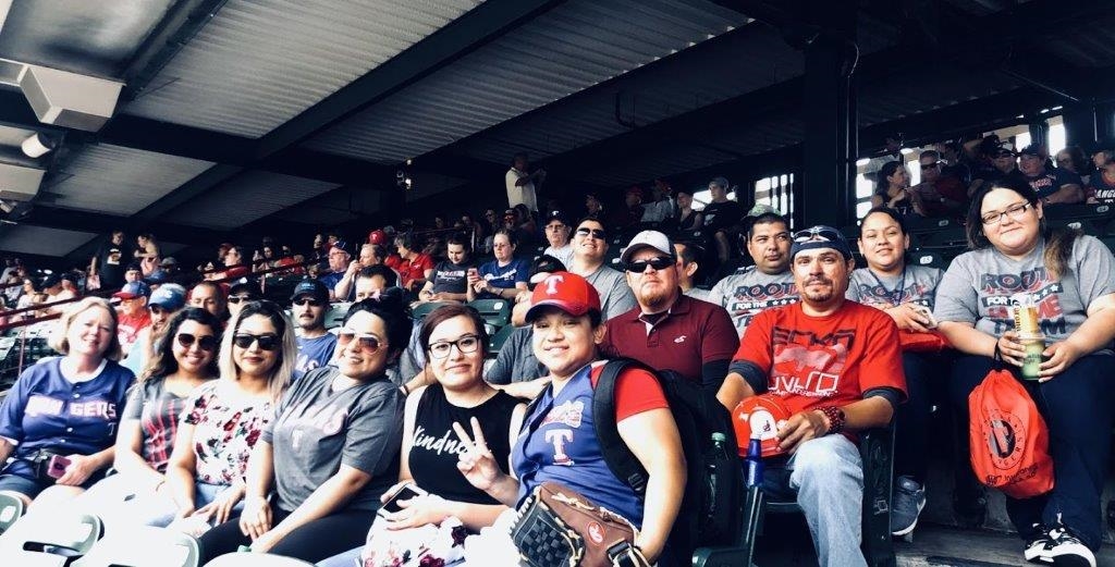 Several team members at a Rangers Game