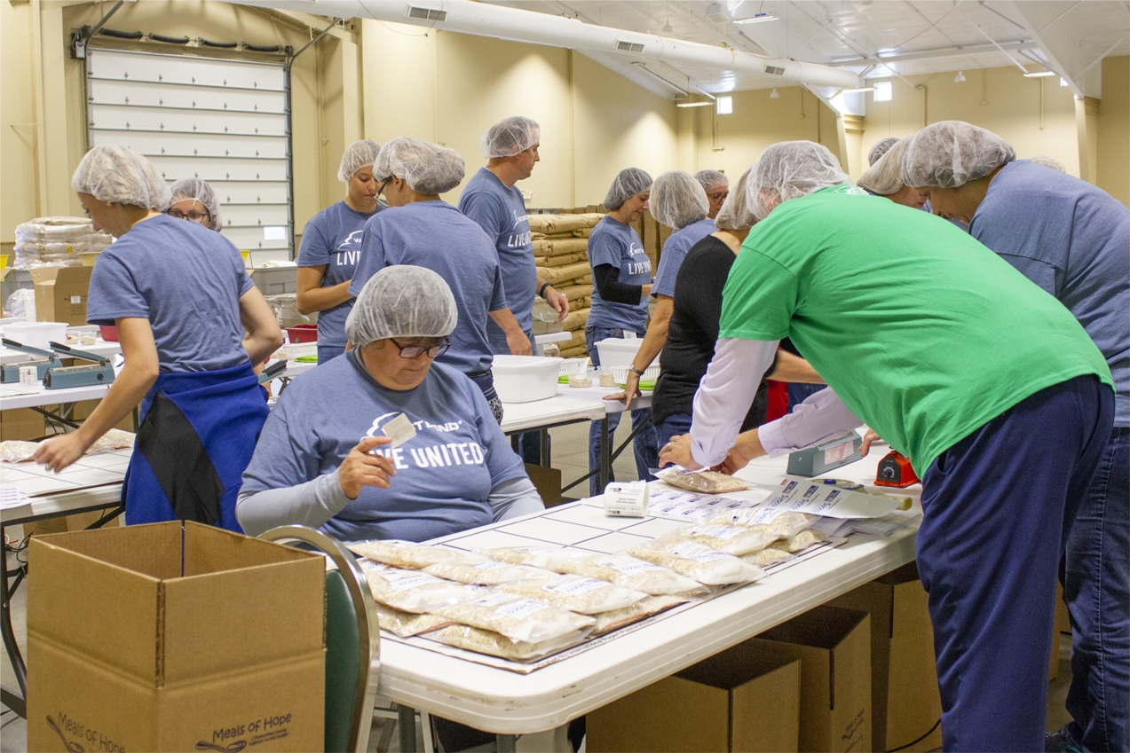 Associate help assemble non-perishable meals as part of the 2019 campaign for the United Way of Washington County.