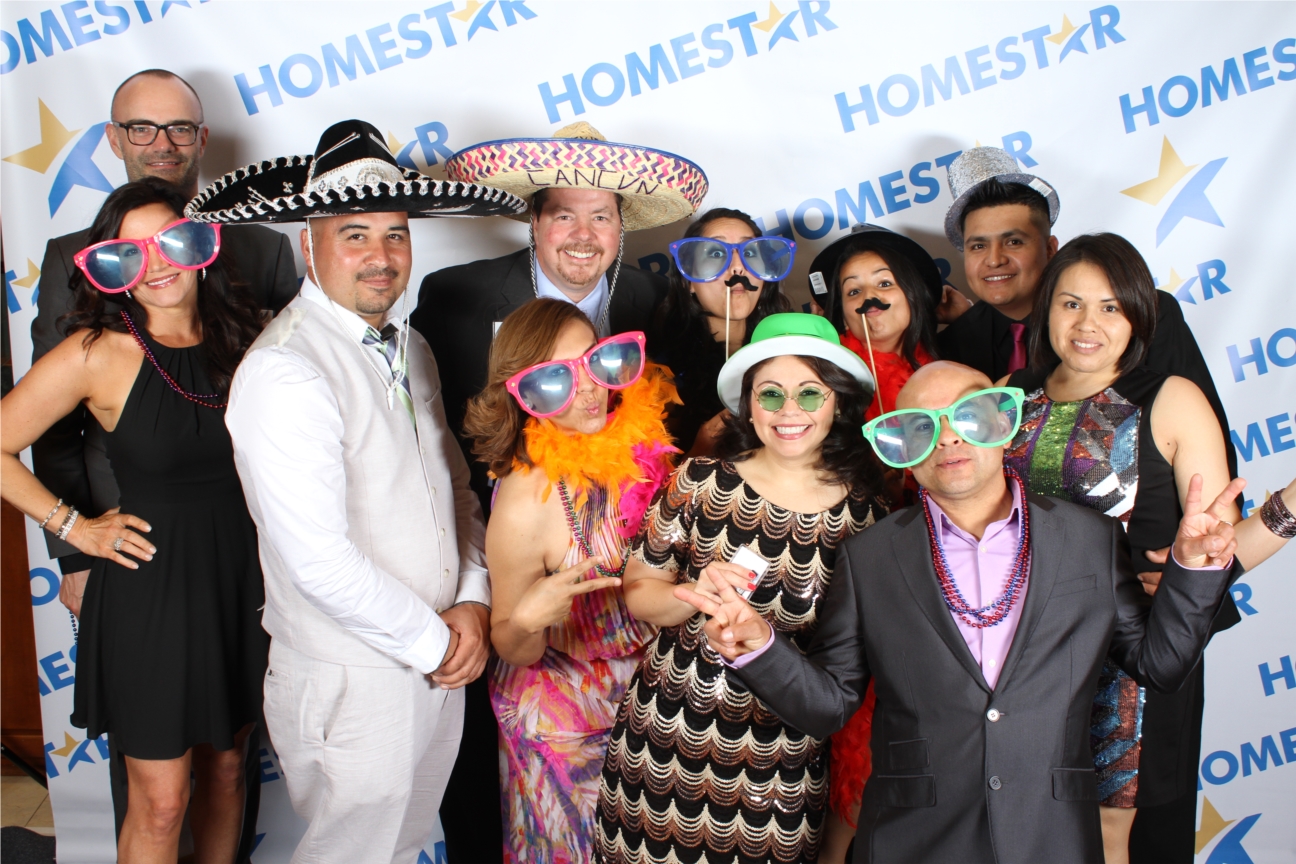 Acting silly and having a fun time with co-workers at HOMESTAR's Annual Ball