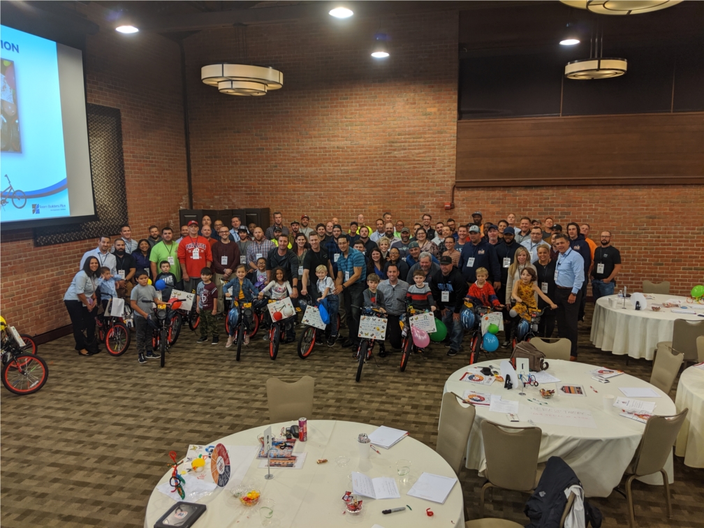 EDA Leadership Academy group shot with children from a local school after they received their new bikes that were built by EDA's leaders. 