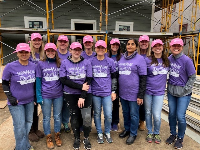 Two Harbors volunteers on site at a Womens Pink Hat build with Habitat for Humanity