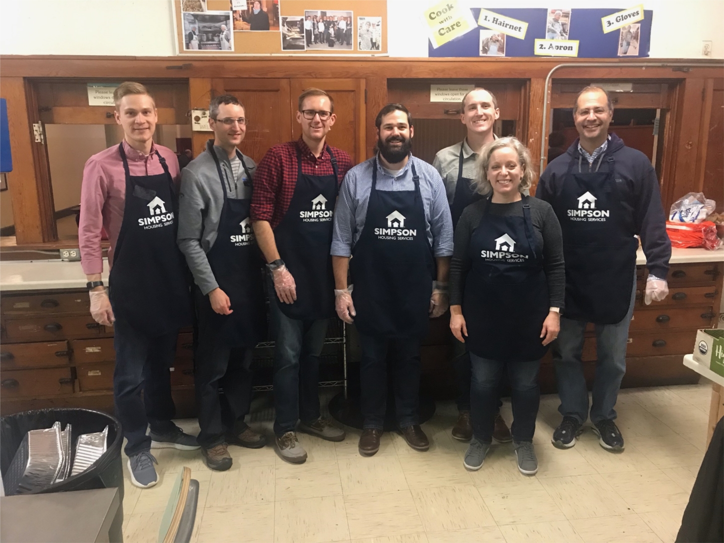 Two Harbors volunteers serving a meal to Simpson Housing residents.