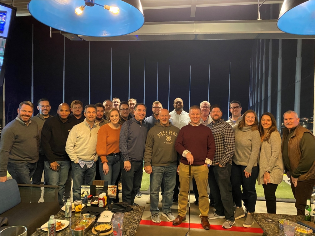 Members of Blue Chip's sales and marketing teams pose for a picture at Topgolf Columbus after a day of team training.