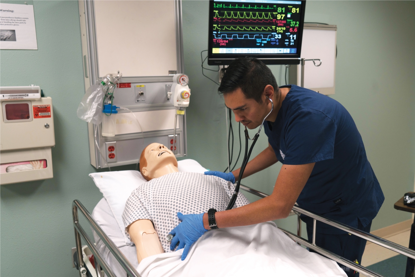 Pima Medical Institute Practical Nursing student 
conducting a patient assessment during simulation training. 