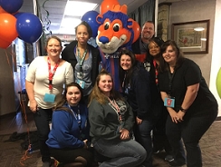 Sharefax employees posing with Gary the mascot from FC Cincinnati during Employee Enrichment Day.
