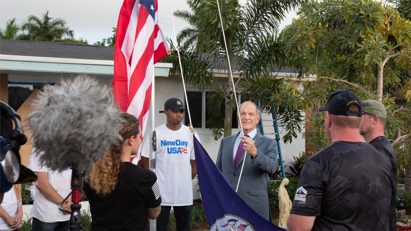 Admiral raising the flag at the Military makeover event
