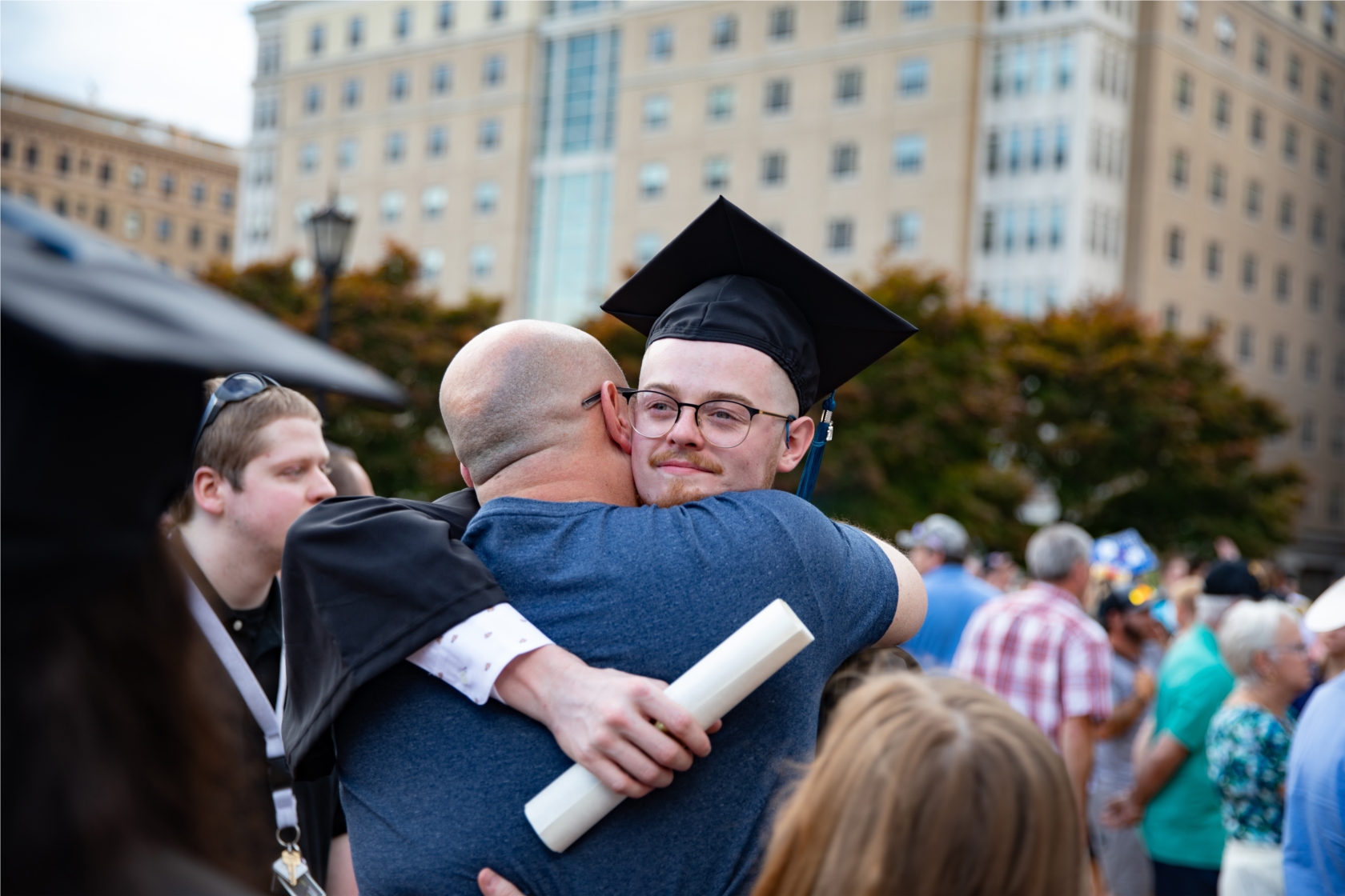 A graduating student celebrates with family and friends. 