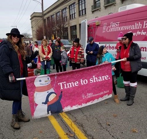 Greensburg area employees proudly carry a First Commonwealth banner in a community parade.