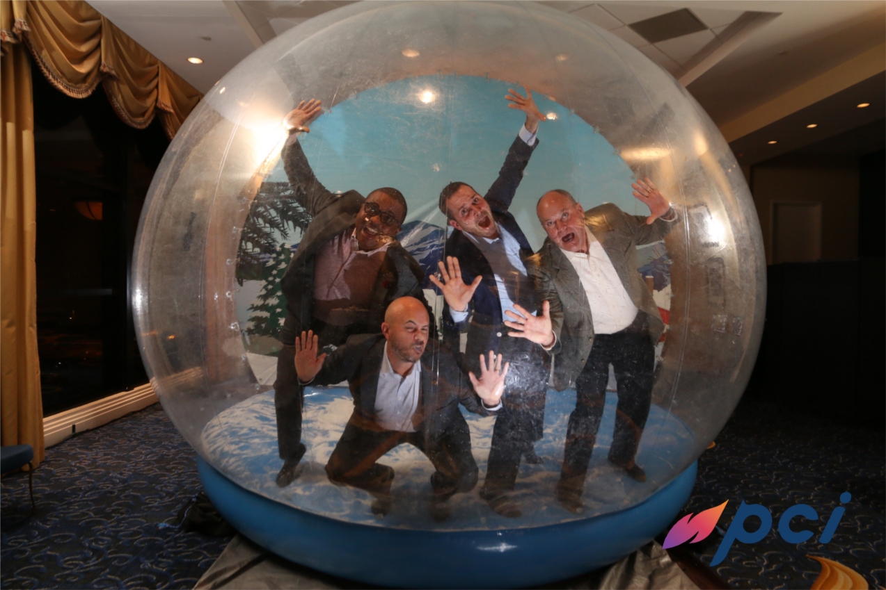 PCI's Leadership Team at the 2020 Holiday Party in Columbia, MD. Front Row: Don Whitfield (Co-Founder and Chief Operating Officer). Back Row (left to right): Sean Battle (Co-Founder and Chief Executive Officer), Josh Kinley (Co-Founder and Chief Financial Officer), and Vance Mitzner (Co-Founder and Chief Technology Officer).