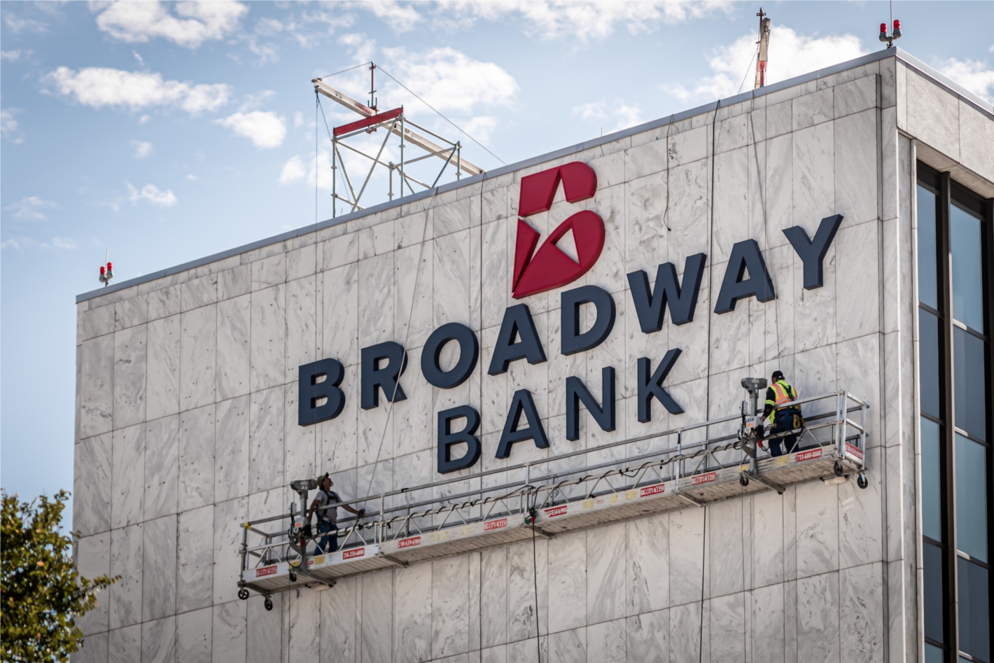 Crews install Broadway Bank's new logo at the Main Financial Center at 1177 N.E. Loop 410 in August. 