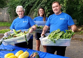 Village Bankers participating in a local volunteer program called Food To Your Table