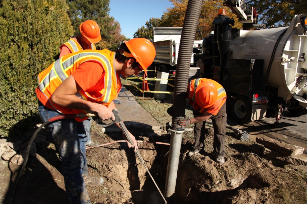 Pipeline maintenance employees repair a waterline break.