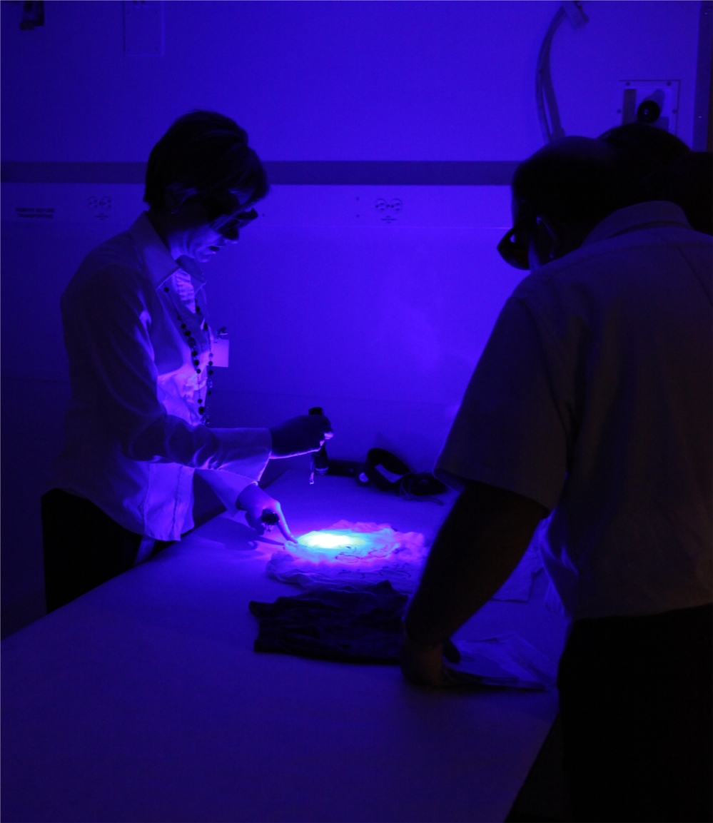NFSTC scientist Carrie Sutherland demonstrates the use of alternative light sources during a training event.