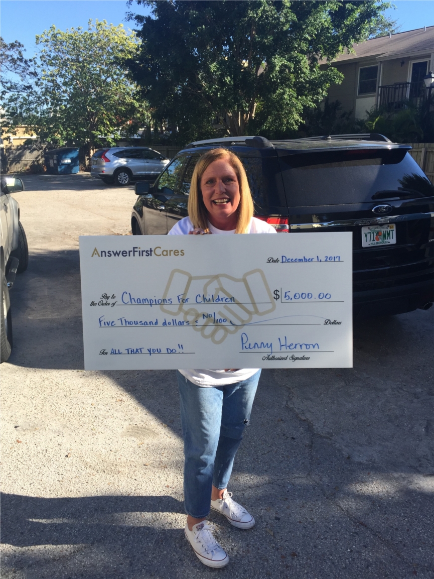 AnswerFirst's Director of Smiles, Penny Herron, dropping off a monetary donation from our charity arm AnswerFirst Cares to Champion's for Children. 