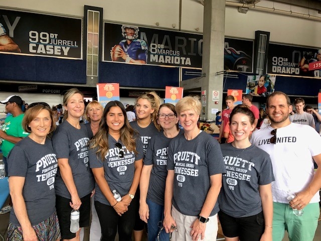 United Way volunteers from Northwestern Mutual fill backpacks with school supplies for the "Stuff the Bus" program. Backpacks were donated to Metro school children at the beginning of the school year.
