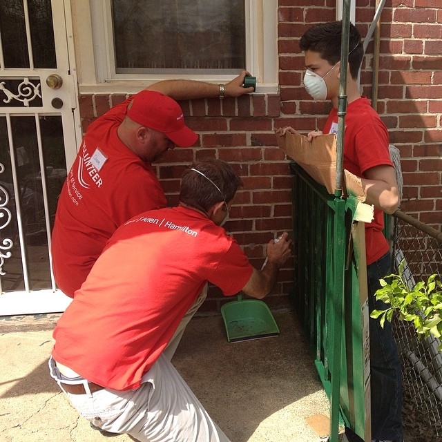 Booz Allen volunteers make repairs to a home in Maryland as part of Rebuilding Together, one of the company's largest firmwide volunteering efforts.
