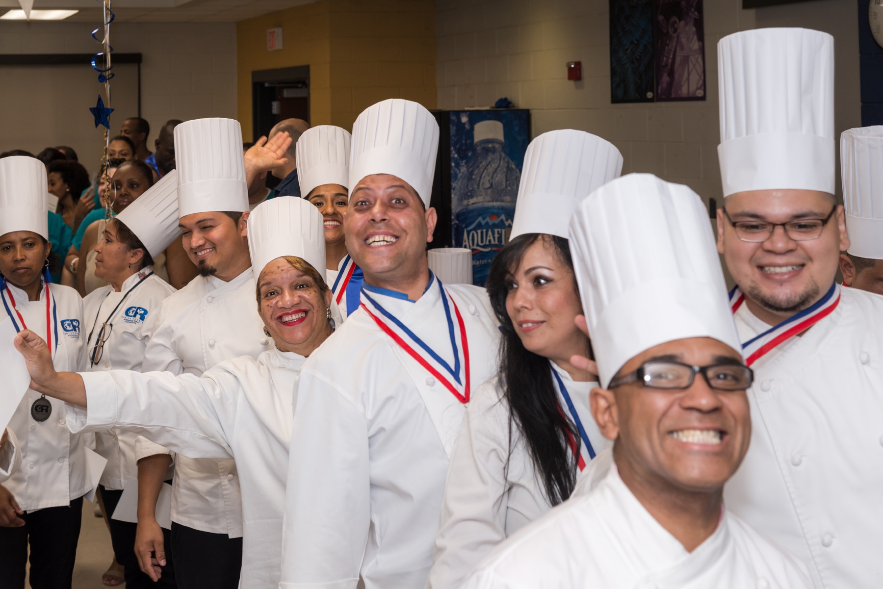 Culinary arts graduates celebrate together at the 2016 graduation ceremony. The Carlos Rosario School offers a culinary arts career training program that prepares students to enter into and excel in food service careers. 