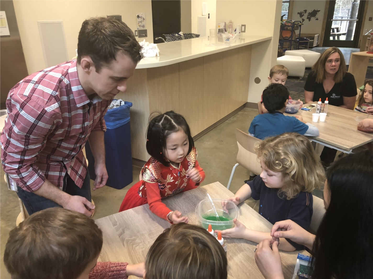 Children at MedImmune’s on-site child care center participate in a slime making activity to learn how medicine is made with MedImmune scientist and parent, Dr. Ryan Cummings. 